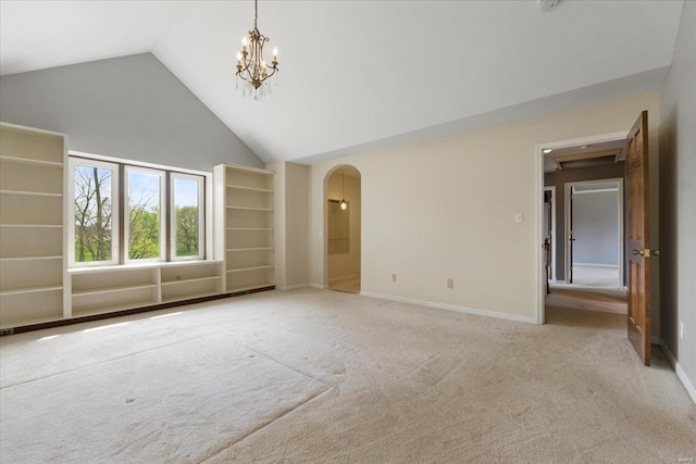 unfurnished living room with a notable chandelier, baseboards, light carpet, high vaulted ceiling, and arched walkways