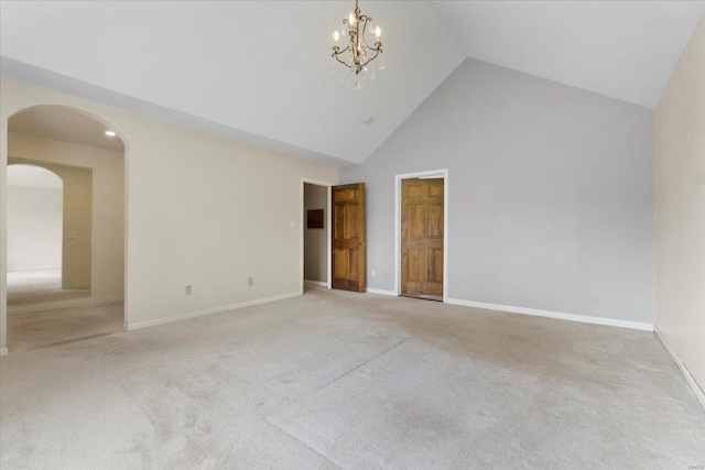 unfurnished bedroom featuring baseboards, high vaulted ceiling, arched walkways, and an inviting chandelier