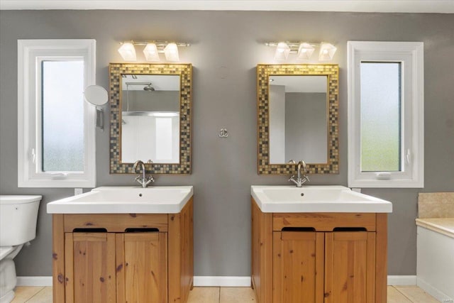 full bathroom with tile patterned flooring, a sink, toilet, and two vanities