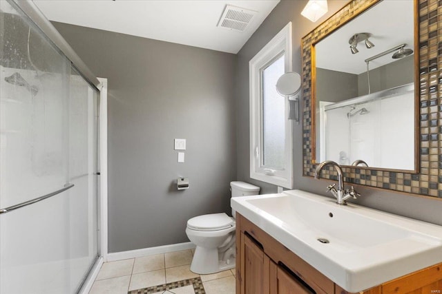full bath with visible vents, toilet, a shower stall, vanity, and tile patterned flooring