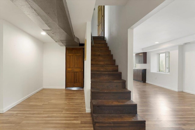 stairs featuring baseboards, recessed lighting, and wood finished floors