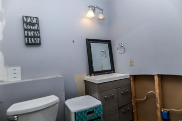 half bath with vanity and toilet