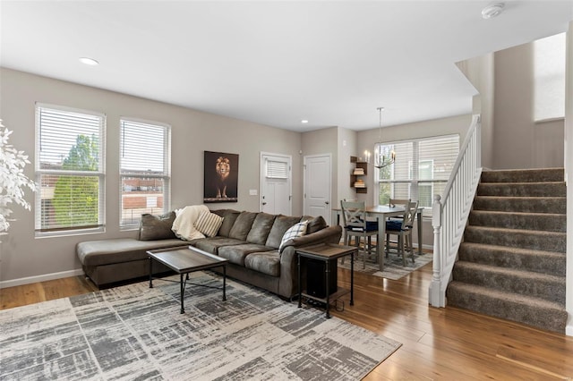 living area with stairway, a chandelier, baseboards, recessed lighting, and wood finished floors