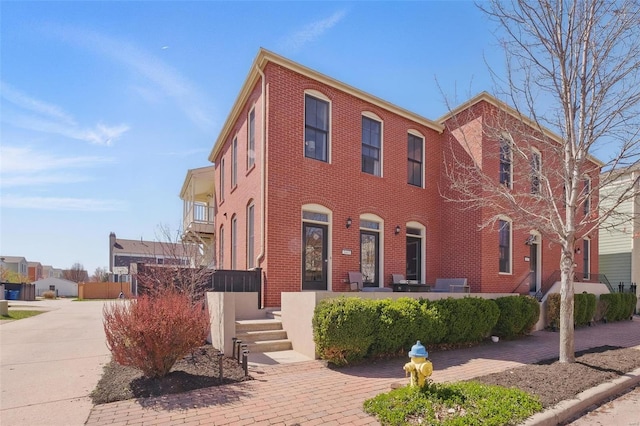 view of front of property featuring brick siding and covered porch