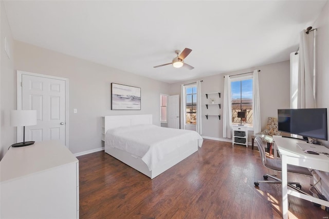 bedroom with a ceiling fan, dark wood-style flooring, and baseboards