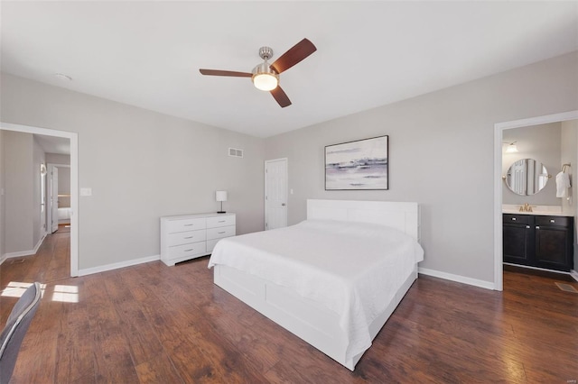 bedroom featuring dark wood finished floors, baseboards, a sink, and a ceiling fan