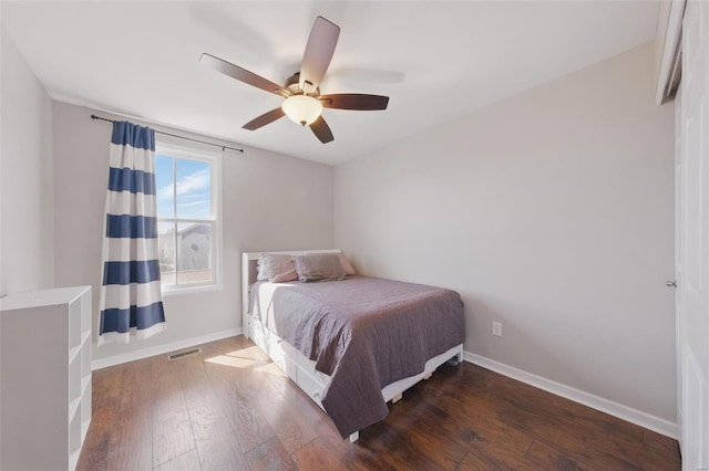 bedroom featuring baseboards, visible vents, a ceiling fan, and hardwood / wood-style floors