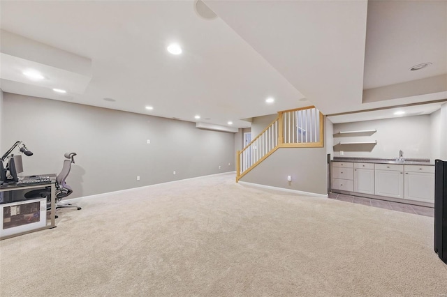 interior space featuring wet bar, light carpet, baseboards, and recessed lighting