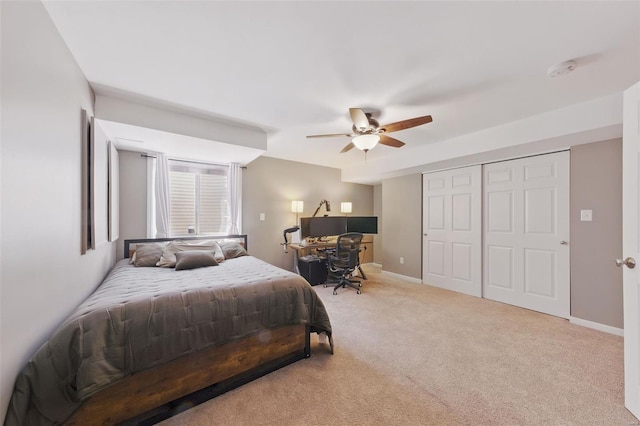 carpeted bedroom featuring baseboards, a closet, and a ceiling fan