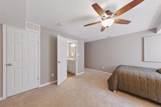 bedroom with ensuite bathroom, visible vents, baseboards, a ceiling fan, and light colored carpet