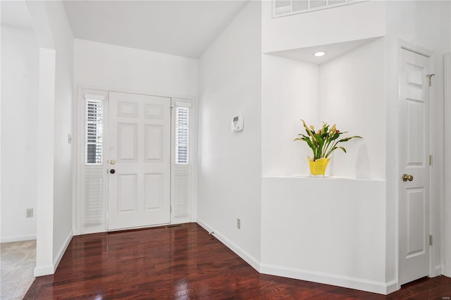 entryway with visible vents, wood finished floors, and baseboards