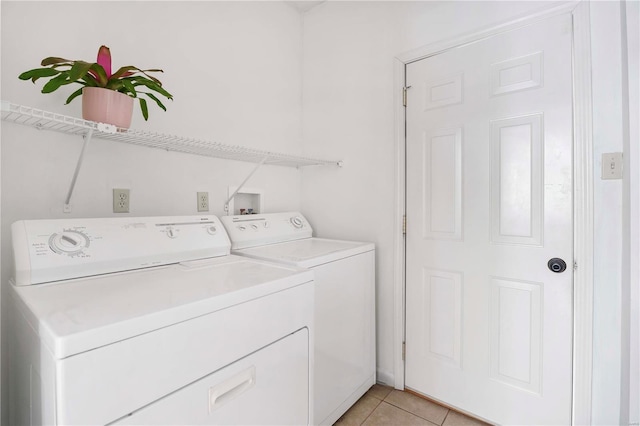 laundry room featuring light tile patterned floors, independent washer and dryer, and laundry area