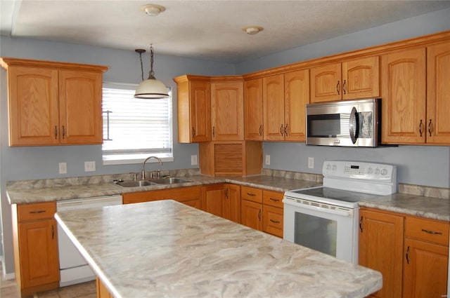 kitchen featuring light countertops, white appliances, hanging light fixtures, a kitchen island, and a sink
