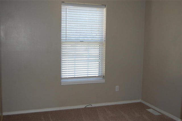 empty room with carpet flooring and baseboards