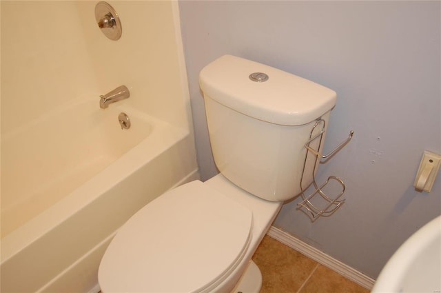 bathroom with toilet, tile patterned floors, and baseboards