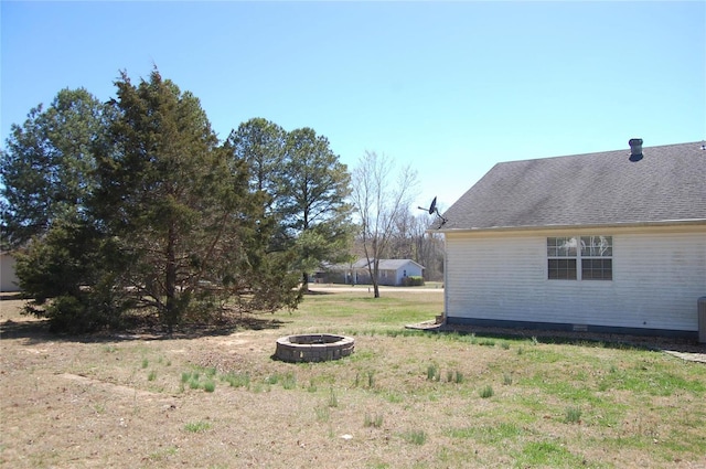 view of yard featuring an outdoor fire pit