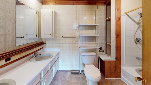 full bathroom featuring vanity, shower / washtub combination, toilet, and tile walls