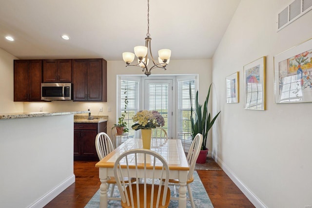 dining room featuring dark wood-style flooring, visible vents, baseboards, recessed lighting, and an inviting chandelier