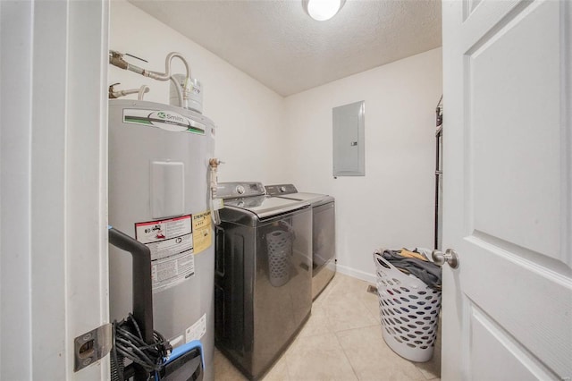 laundry area with water heater, electric panel, laundry area, light tile patterned floors, and washer and dryer
