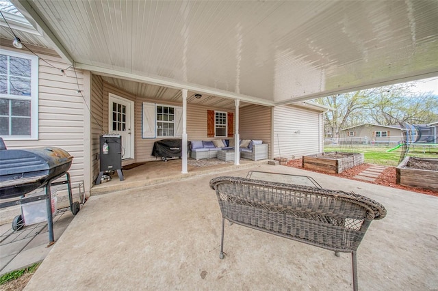 view of patio / terrace with a garden, fence, an outdoor living space, and a grill