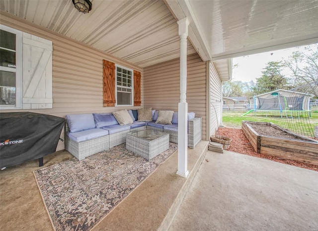 view of patio / terrace featuring a trampoline, fence, and outdoor lounge area