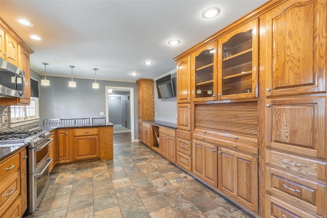 kitchen featuring a peninsula, glass insert cabinets, brown cabinetry, stainless steel appliances, and dark countertops
