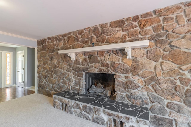 details featuring carpet floors, ornamental molding, baseboards, and a stone fireplace