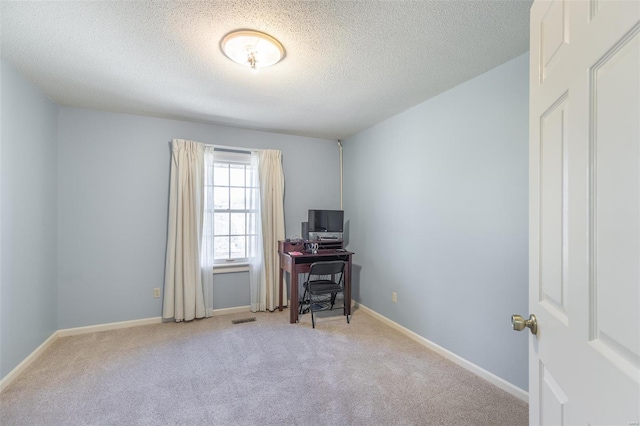 carpeted office space with baseboards, a textured ceiling, and visible vents