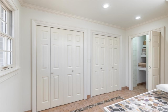 bedroom featuring ornamental molding, multiple windows, multiple closets, and recessed lighting