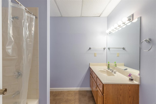 bathroom featuring tile patterned floors, vanity, shower / bathtub combination with curtain, and baseboards