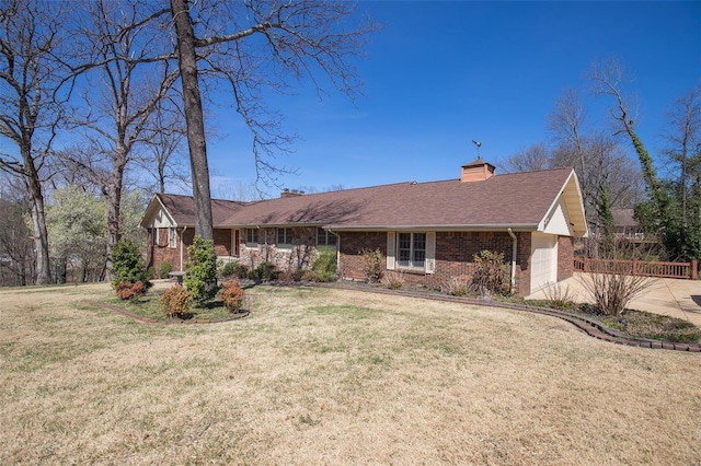 single story home featuring brick siding, a front lawn, and a chimney