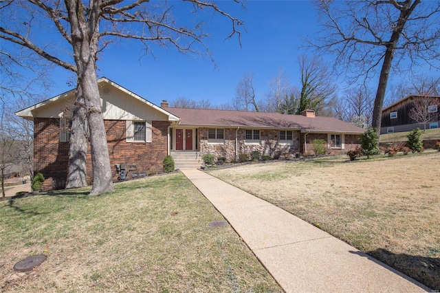 ranch-style home with a chimney, a front lawn, and brick siding