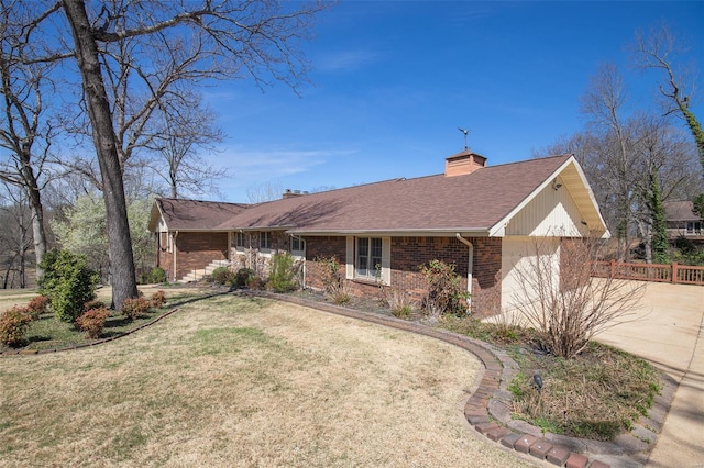 ranch-style home with concrete driveway, an attached garage, a front lawn, brick siding, and a chimney