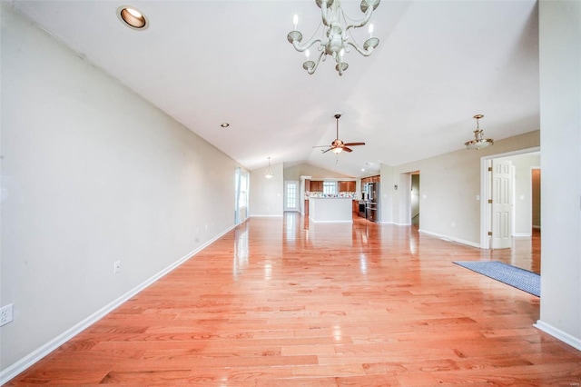 unfurnished living room with light wood-style floors, baseboards, ceiling fan with notable chandelier, and lofted ceiling