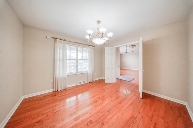 unfurnished dining area with baseboards, a notable chandelier, visible vents, and light wood-style floors