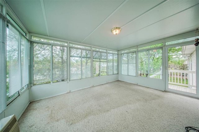 unfurnished sunroom featuring an AC wall unit