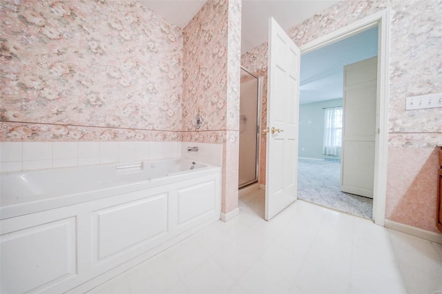 full bathroom featuring wallpapered walls, a wainscoted wall, a garden tub, and a stall shower