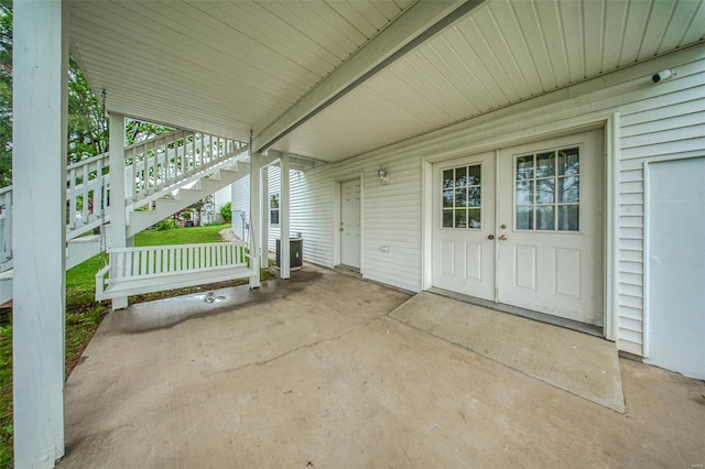 view of patio / terrace featuring cooling unit and stairs