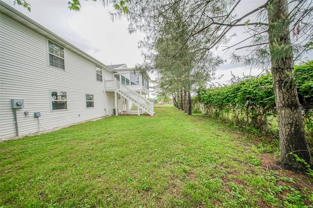 view of yard with a wooden deck and stairway