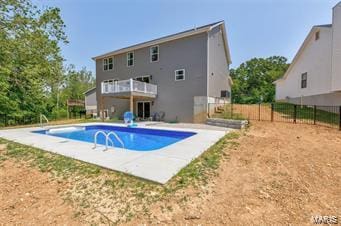 view of swimming pool featuring a fenced in pool, fence, and a patio area
