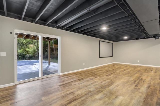 unfurnished room featuring baseboards and wood finished floors