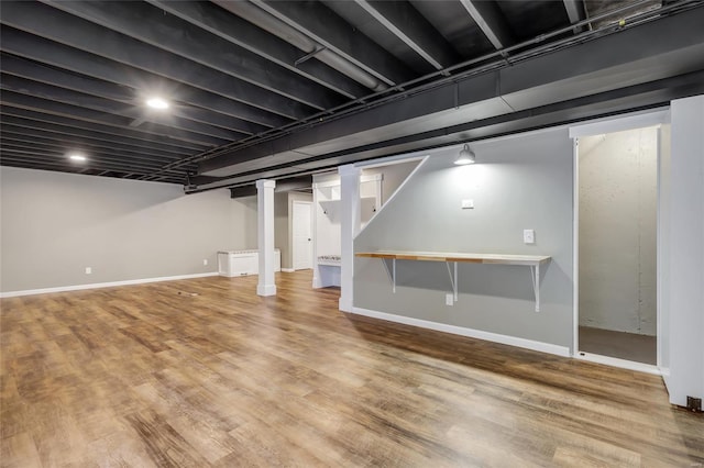finished basement featuring baseboards and wood finished floors