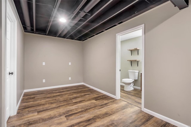 finished basement with baseboards and wood finished floors