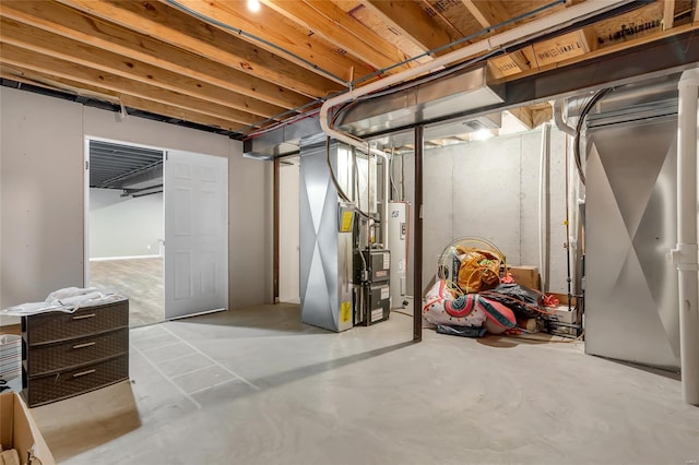 unfinished basement with heating unit and electric water heater