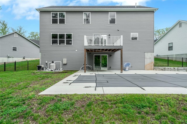 back of house featuring central AC unit, a patio area, fence, and a yard
