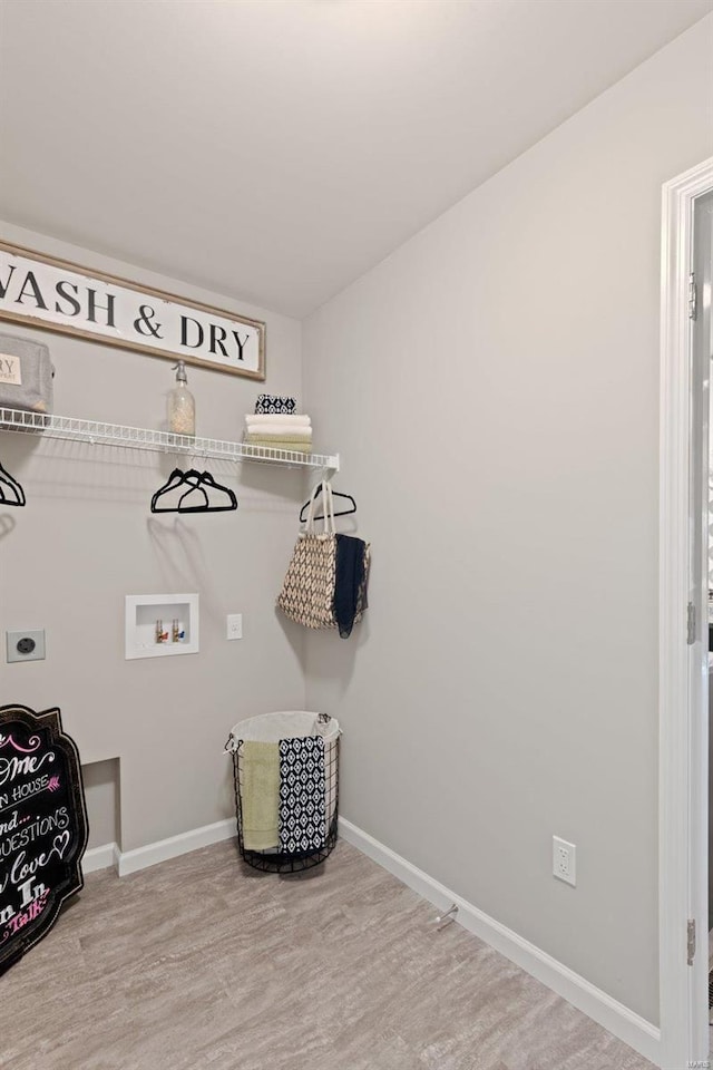 laundry room with wood finished floors, electric dryer hookup, laundry area, baseboards, and hookup for a washing machine