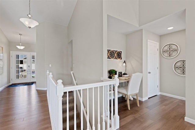 foyer entrance featuring baseboards and wood finished floors