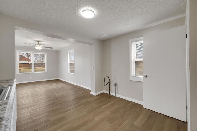 interior space featuring baseboards and wood finished floors