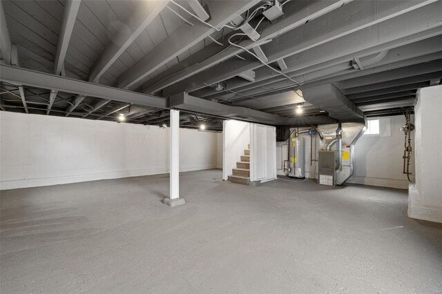 below grade area with heating unit, water heater, and stairway