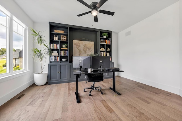 home office featuring a ceiling fan, visible vents, and plenty of natural light